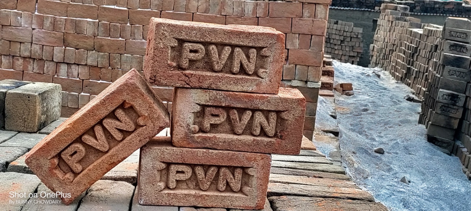 Four red bricks with the PVN stamp resting on a stack
